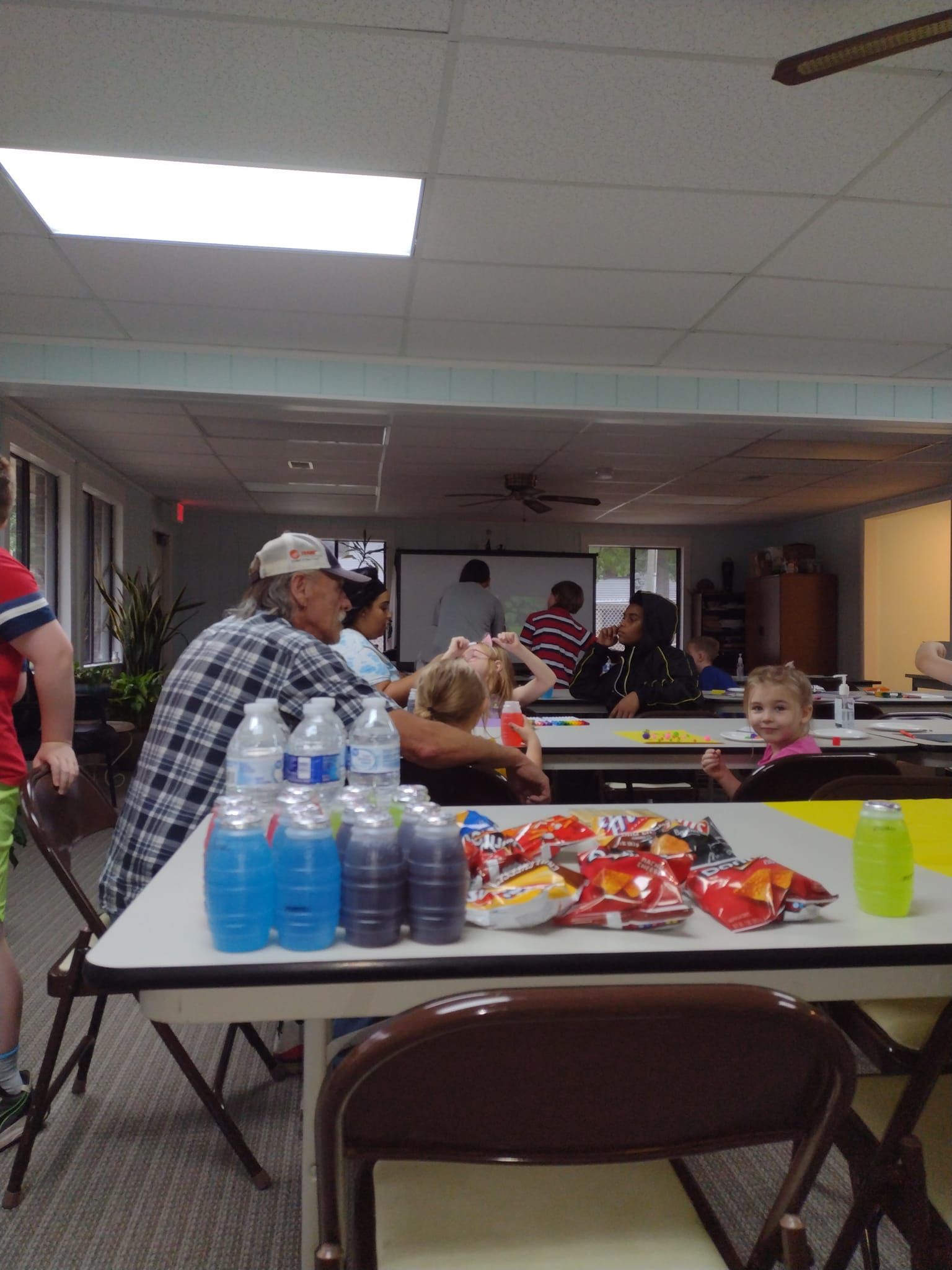 Community gathering showing multiple generations enjoying arts activities together at FCCAC